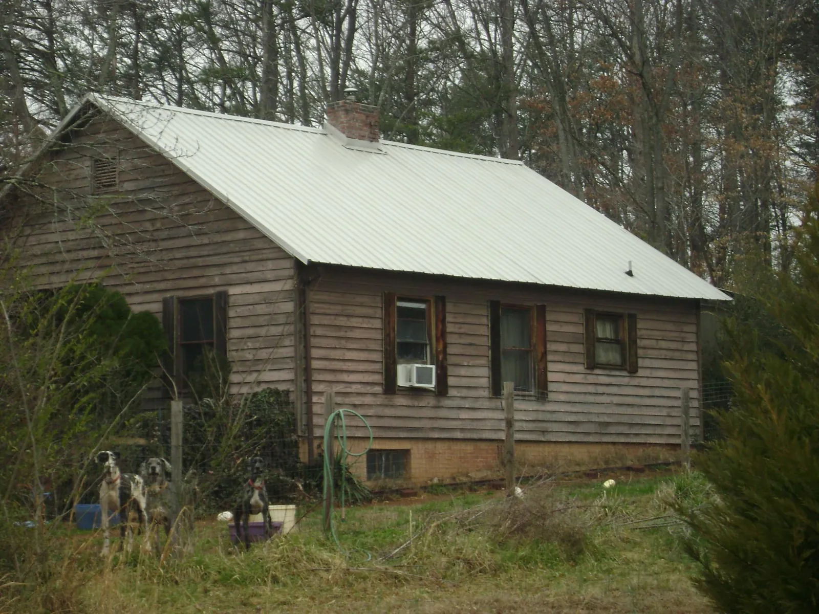 White metal roof on an old wood sided farmhouse, from a Metal Roof Installation job in Mc Coll